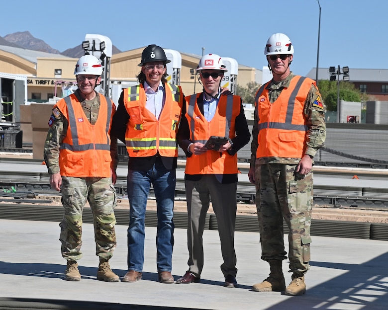 The key participants in the first bead-laying ceremony for the 3D-printed buildings on Fort Bliss are pictured left to right: U.S. Army Corps of Engineers’ Southwestern Division Commander Brig. Gen. George Walter, ICON CEO Jason Ballard, Assistant Secretary of the  Army (IE&E) the Honorable W. Jordan Gillis and 1st Armored Division and Fort Bliss Commander Maj. Gen. Curtis Taylor. Using a tablet, they initiated the construction-scale 3D printer to lay the next level of a future barracks. In total, 10 new barracks will be constructed over a six-month period. Each of the barracks will house up to 56 soldiers deployed to the West Texas Army base.