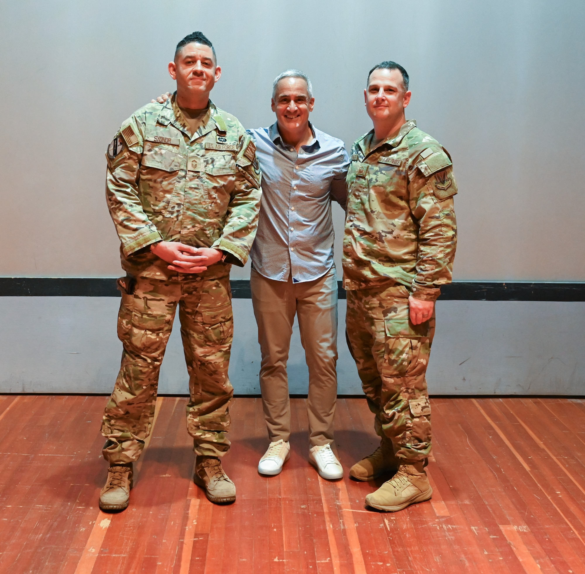 Three pose pose for a photo