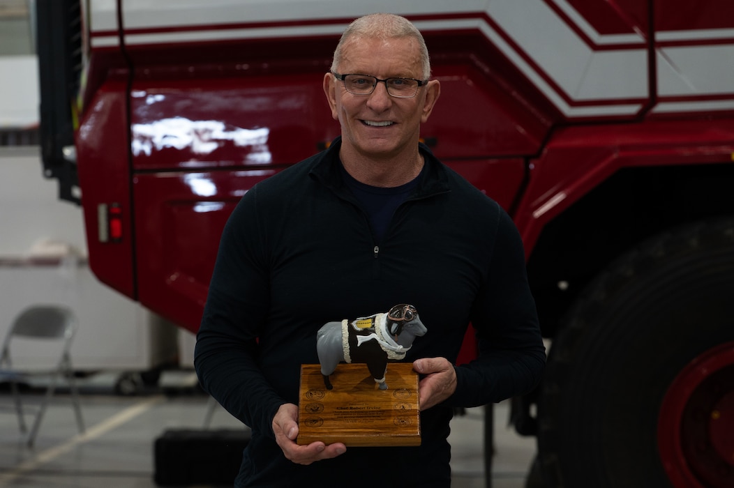 Chef Robert Irvine, a celebrity culinary chef, poses for a photo with thank you gift at the Louis F. Garland Fire Academy, Goodfellow AFB, Texas, March 6, 2026. U.S. Air Force Col. Matthew Norton, 17th Training Wing commander, presented Irvine with the sheep during a Breaking Bread with Heroes Luncheon, and thanked him serving those who serve.