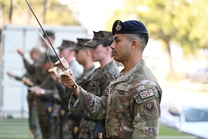 A U.S. Air Force security forces Airman assigned to the 1st Special Operations Wing participates in a sword and guidon lesson during Marine Corps Corporal Course, Class 1-26, at Naval Air Station Pensacola, Florida, Feb. 17, 2026.