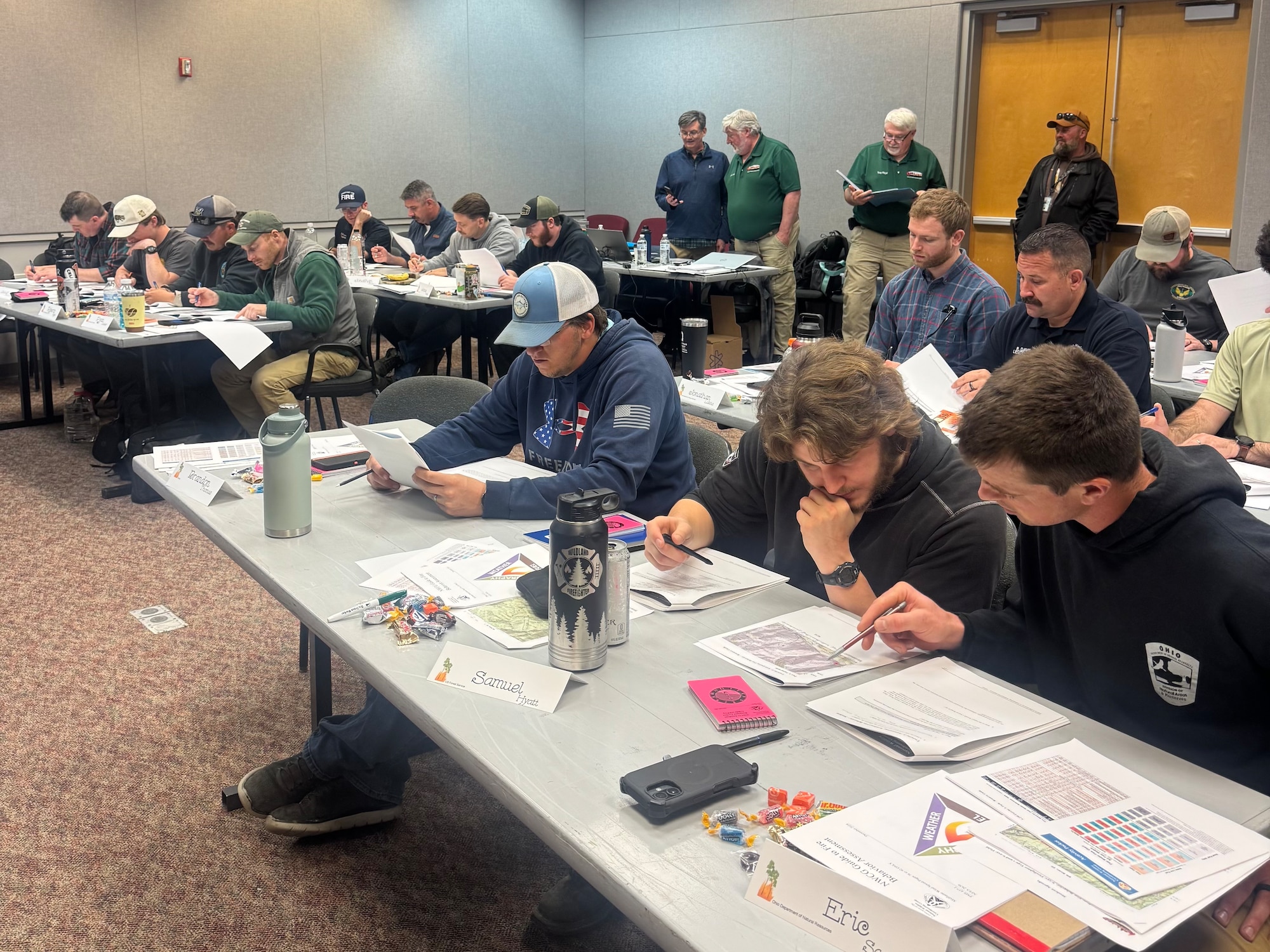 Military and civilian personnel take part in classroom instruction during a multi-agency wildland fire training event at Wright-Patterson Air Force Base.