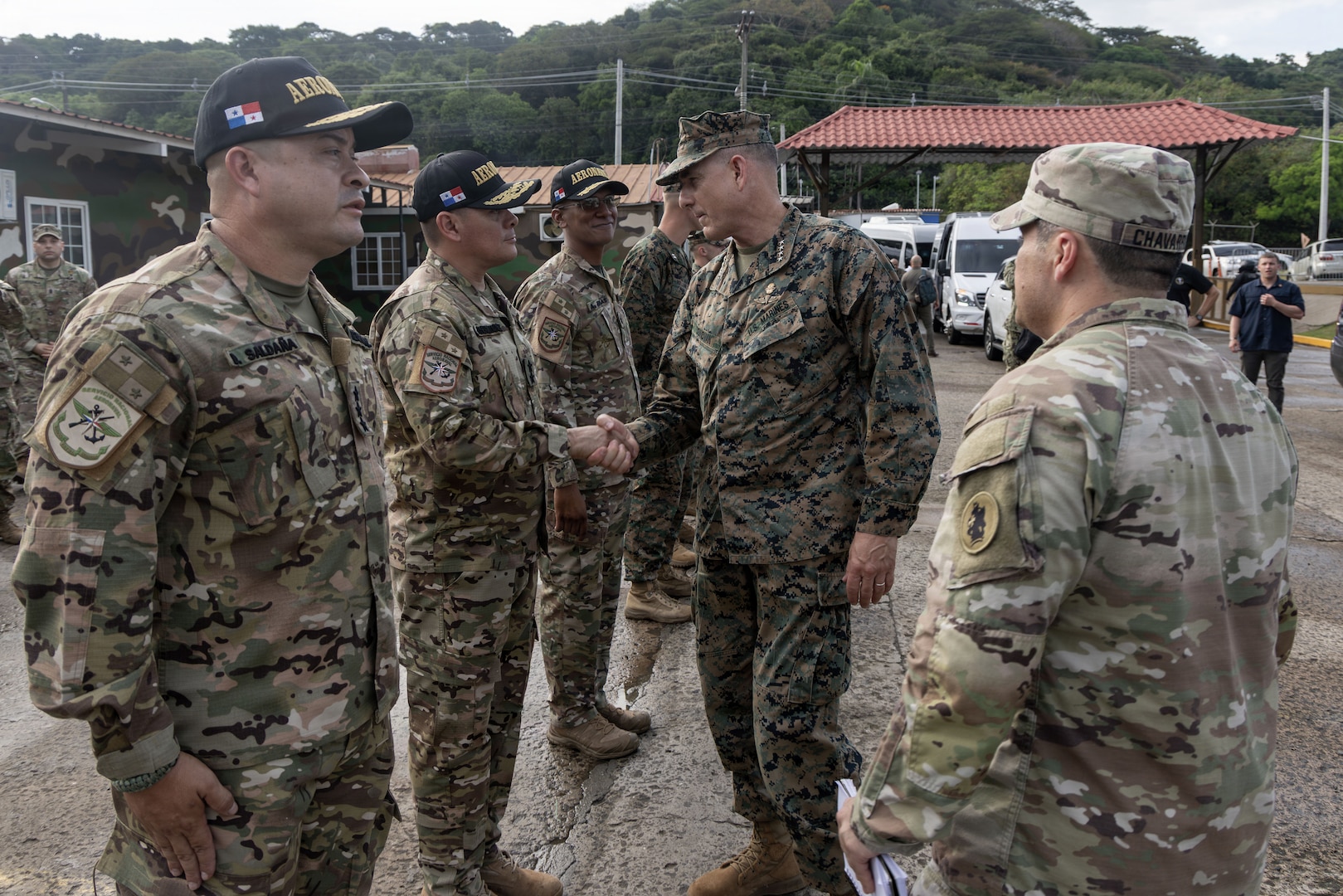 Personnel in military uniform shake hands.