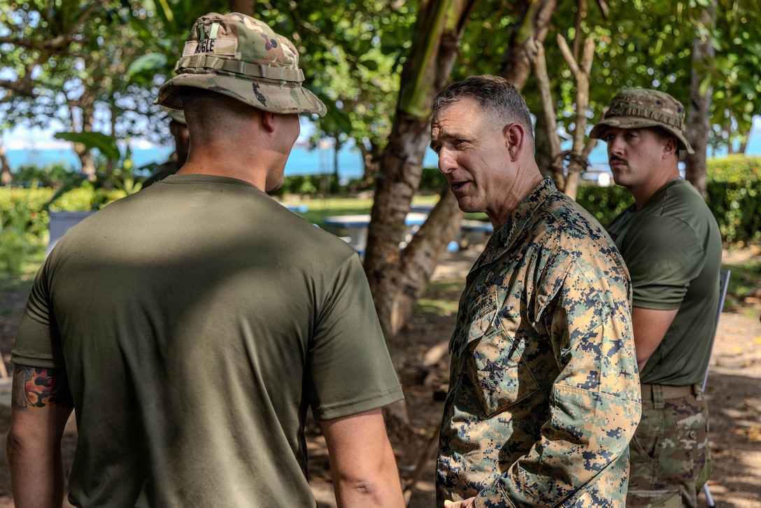 Two men speak to each other.
