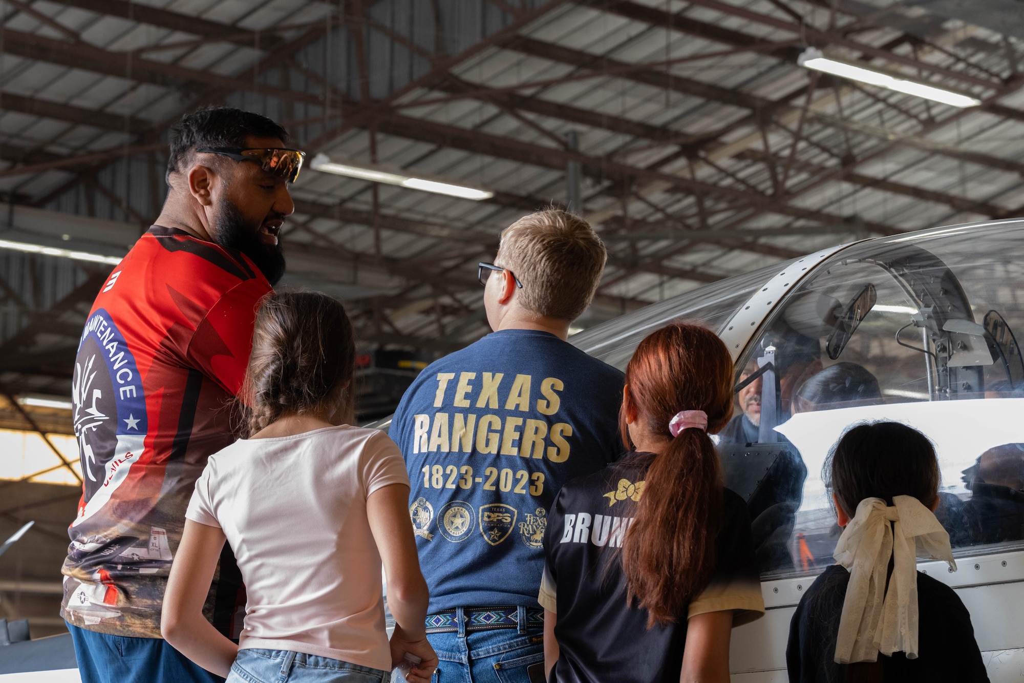 A T-6A Texan II aircraft maintainer assigned to the 47th Maintenance Directorate converses with attendees of the Fiesta of Flight STEM Expo at Laughlin Air Force Base, Texas, March 27, 2026. Guests were given the opportunity to learn about the T-6 Texan and T-38 Talon aircrafts. (U.S. Air Force photo by Airman 1st Class Darryl Keith)