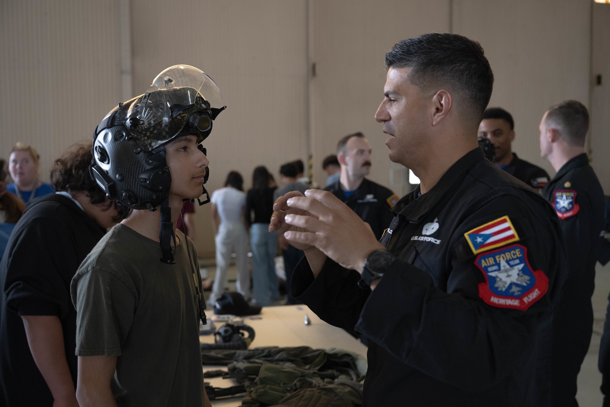 A guest of the Fiesta of Flight STEM Expo listens to U.S. Air Force Staff Sgt. Jose Flores-Velez, F-35A Lightning II Demonstration Team dedicated crew chief, at Laughlin Air Force Base, Texas, March 27, 2026. Flores-Velez educated guests about his team and Air Force career. (U.S. Air Force photo by Airman 1st Class Darryl Keith)