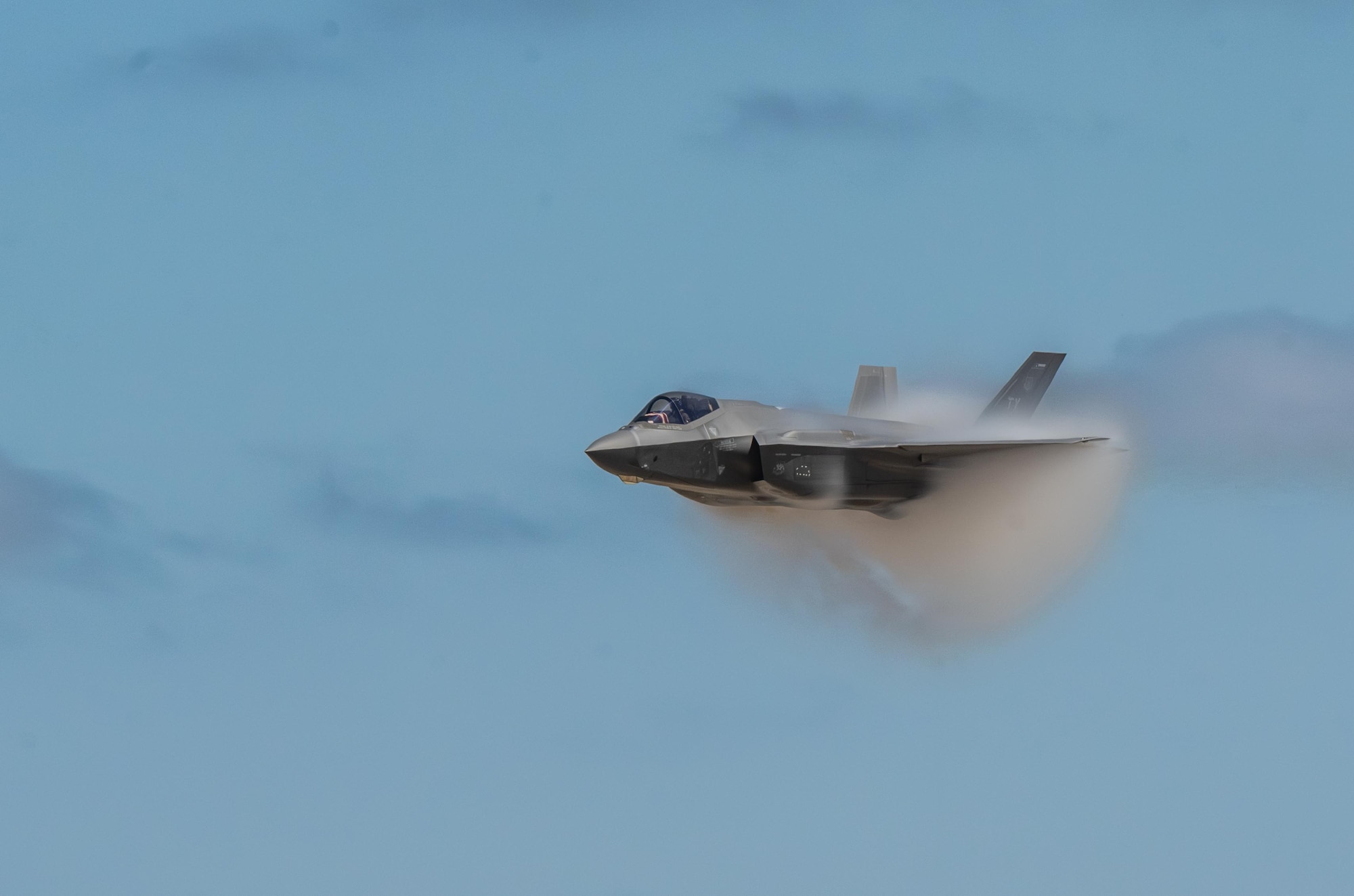 An F-35 Lightning II executes a high speed pass during the Fiesta of Flight airshow at Laughlin Air Force Base, Texas, March 28, 2026. The fifth-generation fighter showcases advanced stealth and multi-role capabilities. (U.S. Air Force photo by Airman 1st Class Harrison Sullivan)