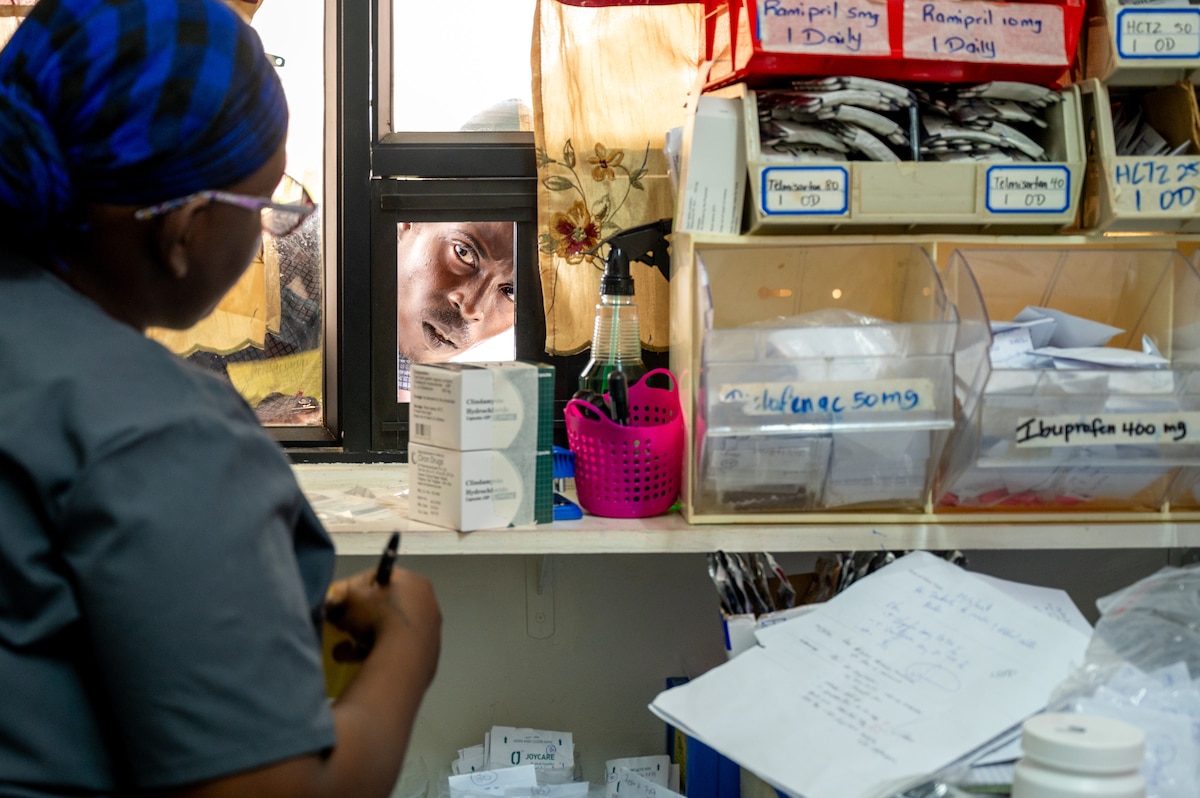 A Guyanese patient speaks with a pharmacy technician at the West Demerara Regional Hospital outpatient pharmacy in Vreed en Hoop, Guyana, March 20, 2026. As part of the Lesser Antilles Medical Assistance Team (LAMAT) 2026 mission, U.S. Air Force medical professionals worked alongside partner nation medical providers to sharpen clinical readiness and strengthen lasting partnerships in the region. (U.S. Air Force photo by Maj. Stephani Schafer)