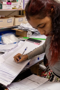Darshanie Singh, a Guyanese pharmacy technician, updates pharmaceutical records at the West Demerara Regional Hospital outpatient pharmacy in Vreed en Hoop, Guyana, March 20, 2026. As part of the Lesser Antilles Medical Assistance Team (LAMAT) 2026 mission, U.S. Air Force medical professionals worked alongside partner nation medical providers to sharpen clinical readiness and strengthen lasting partnerships in the region. (U.S. Air Force photo by Maj. Stephani Schafer)