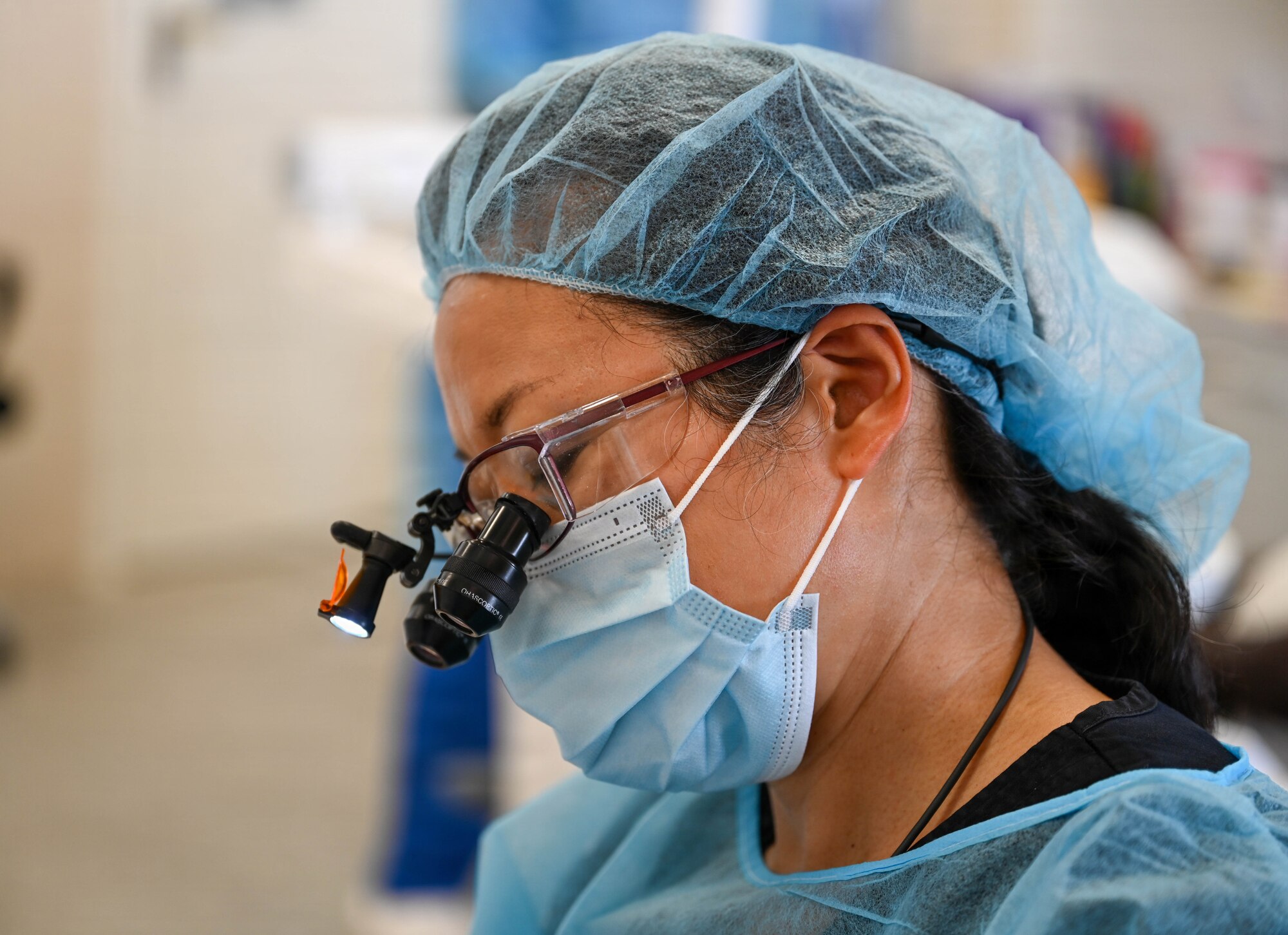 U.S. Air Force Lt. Col. Eirleen Hyun, 349th Medical Squadron dentist, performs a dental procedure at De Kinderen Regional Hospital in West Coast Demerara, Guyana, March 17, 2026. The Lesser Antilles Medical Assistance Team (LAMAT) 2026 mission focused on building medical readiness and strengthening professional bonds through hands-on clinical engagement with host nation counterparts. (U.S. Air Force photo by Staff Sgt. Dakota Carter)