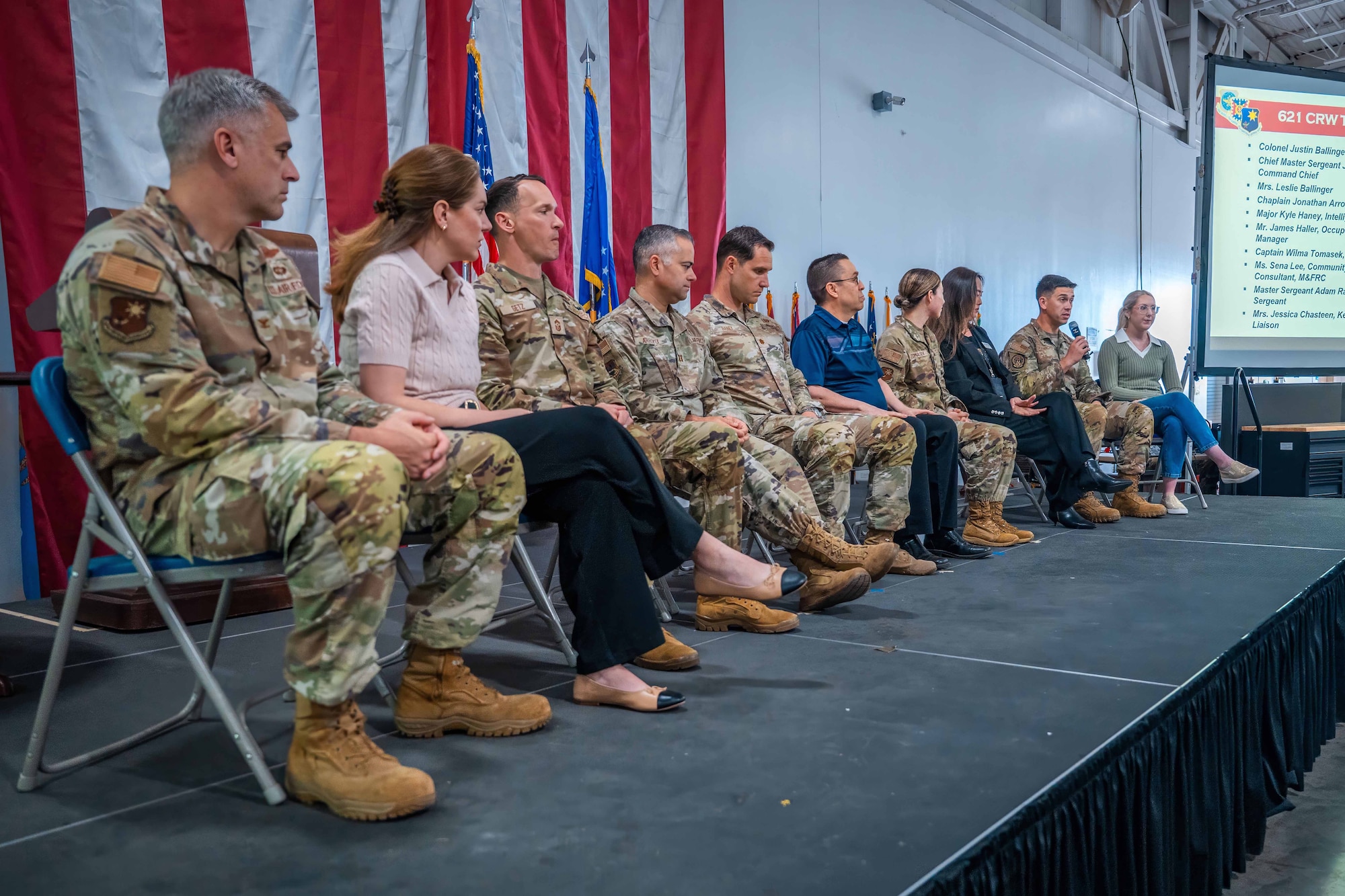 People sit in a line on stage.