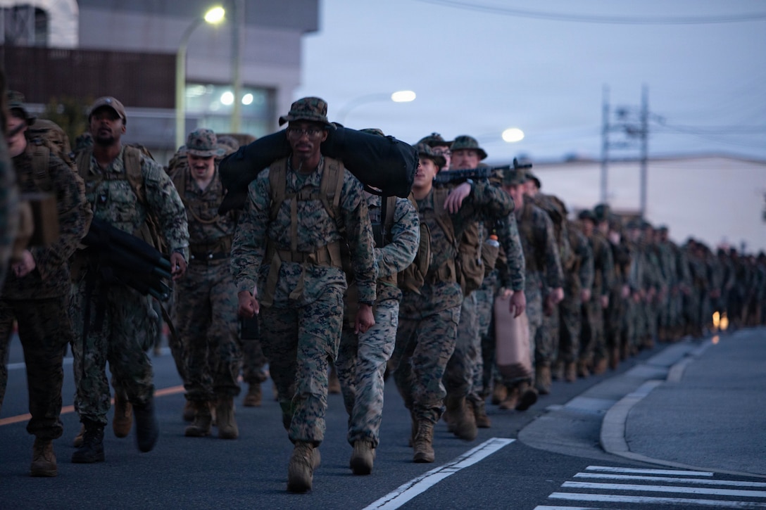 U.S. Marines and Sailors with Headquarters and Headquarters Squadron (HHS), Marine Corps Air Station Iwakuni, participated in a squadron hike at MCAS Iwakuni, Japan, March 27, 2026. The purpose of the hike was to maintain readiness by increasing physical fitness and to improve the squadrons camaraderie. (U.S. Marine Corps photo by Sgt. Peter Rawlins)