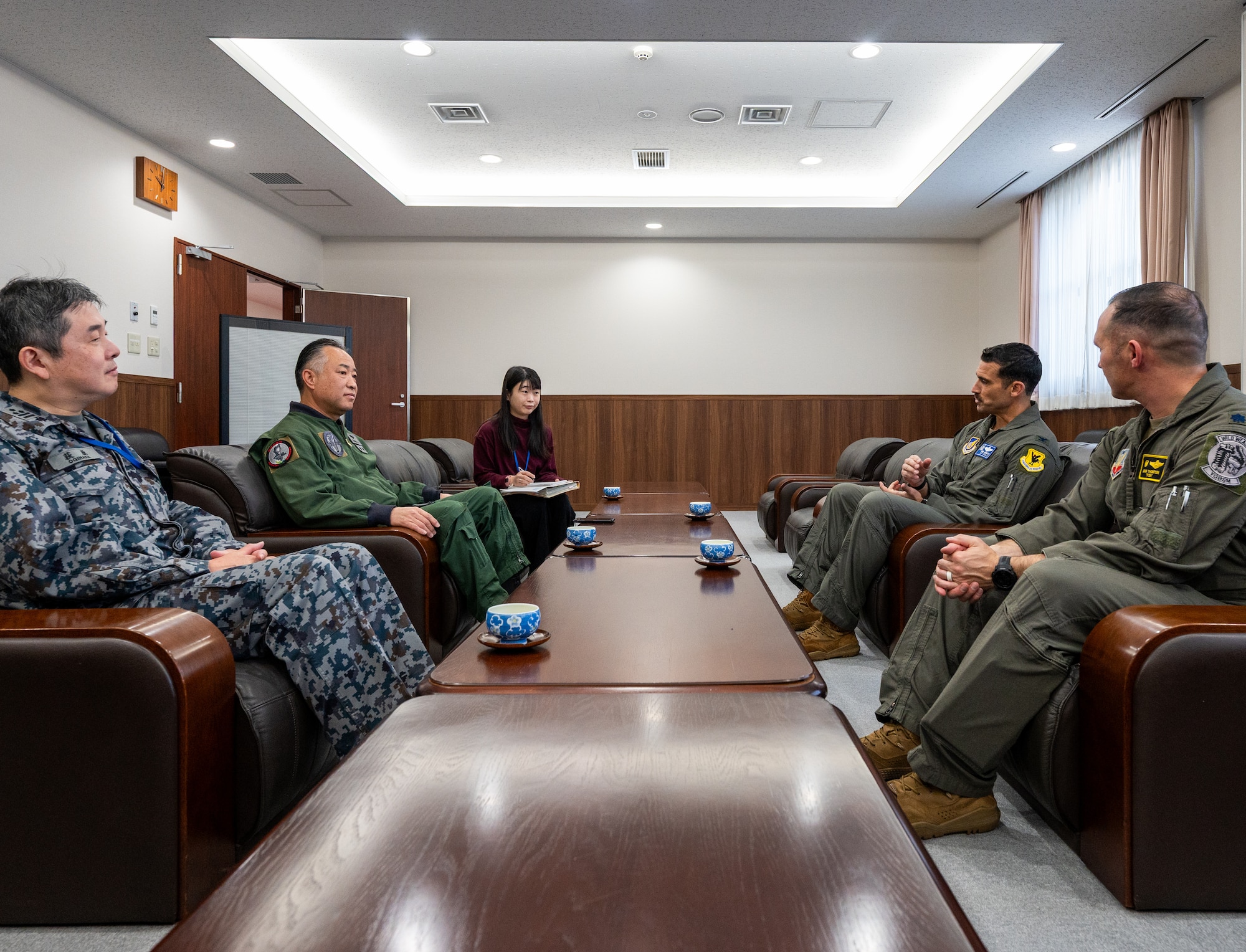 U.S. Air Force and Japan Air Self-Defense Force leadership from the 18th Wing, 5th Air Wing, and 4th Expeditionary Fighter Squadron, meet during Nyutabaru Aviation Training Relocation exercise 26-1, at Japan Air Self-Defense Force Nyutabaru Air Base, Japan.