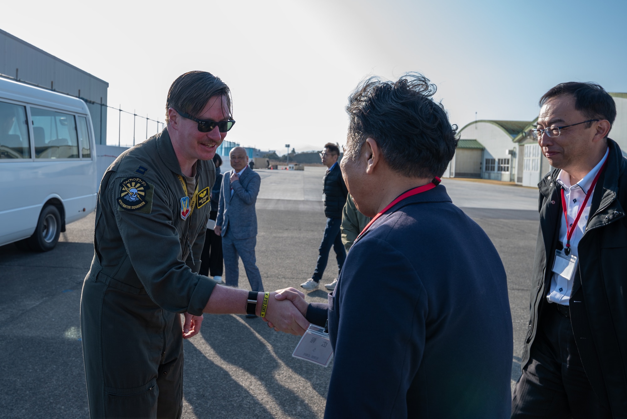U.S. Air Force Capt. Harry McMahon, 4th Expeditionary Fighter Squadron F-35A Lightning II pilot, shakes hands with local base support group members during Nyutabaru Aviation Training Relocation exercise 26-1 at Japan Air Self-Defense Force Nyutabaru Air Base, Japan.