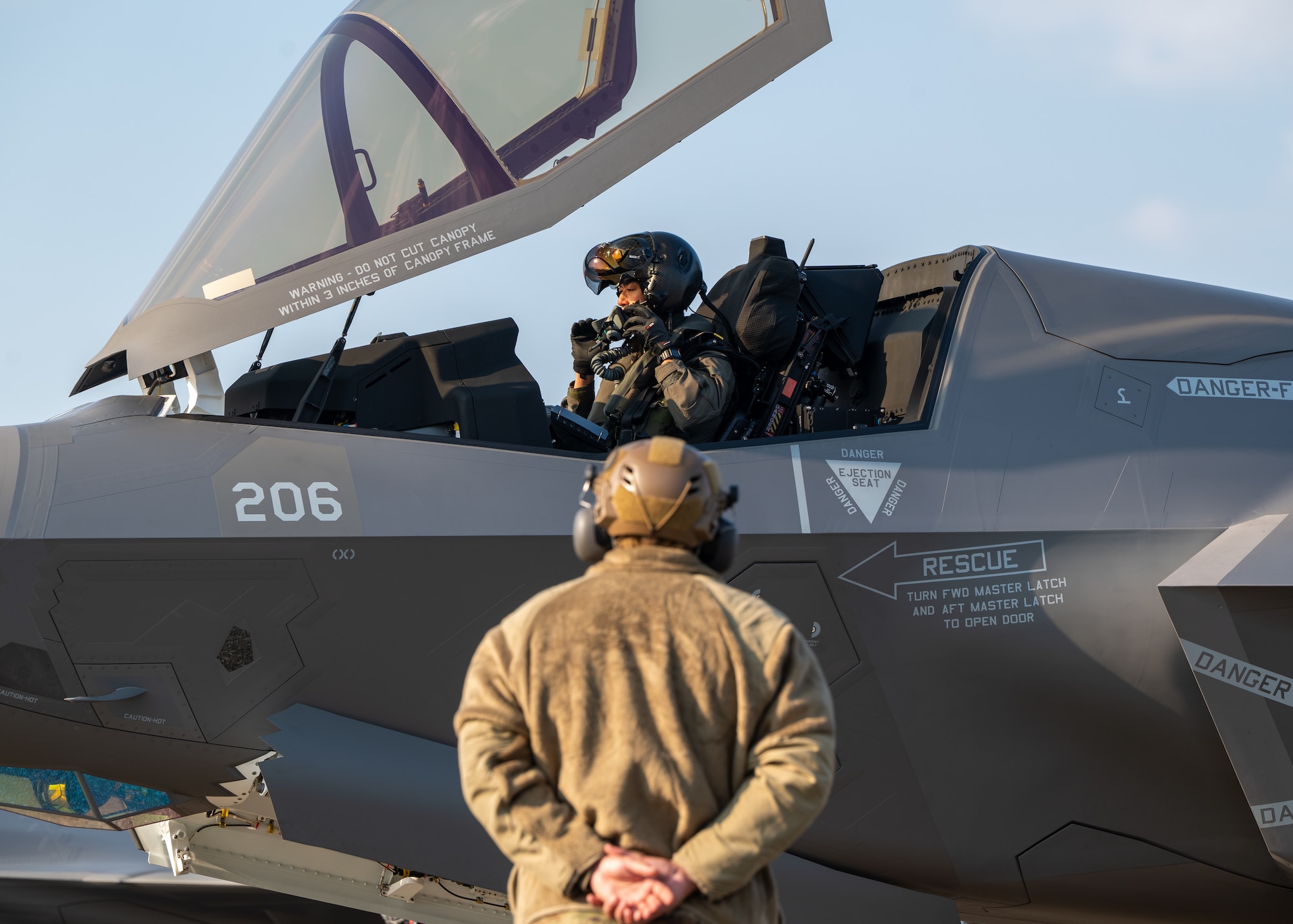 U.S. Air Force Senior Airman Zachary Helmer, 4th Expeditionary Fighter Generation Squadron crew chief, prepares to marshal a Japan Air Self-Defense Force F-35B Lightning II during Nyutabaru Aviation Training Relocation Exercise 26-1, at JASDF Nyutabaru Air Base Japan.