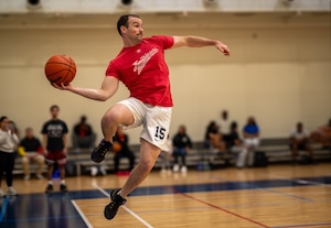A participant jumps while throwing a basketball.