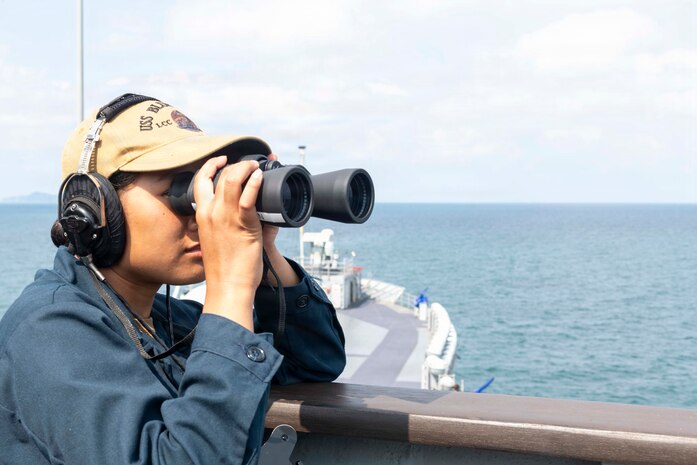 Logistics Specialist Seaman May Nyein stands forward lookout aboard U.S. 7th Fleet flagship USS Blue Ridge (LCC 19) as the ship departs Laem Chabang, Thailand following a scheduled port visit, March 30, 2026.