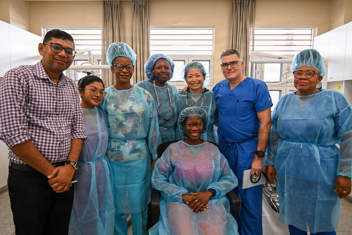 U.S. Airmen pose for a photo alongside Guyanese healthcare providers at De Kinderen Regional Hospital in West Coast Demerara, Guyana, March 17, 2026. This side-by-side engagement was a key component of the Lesser Antilles Medical Assistance Team 2026 mission, allowing both nations to share specialized expertise while providing patient care to the local community. (U.S. Air Force photo by Staff Sgt. Dakota Carter)