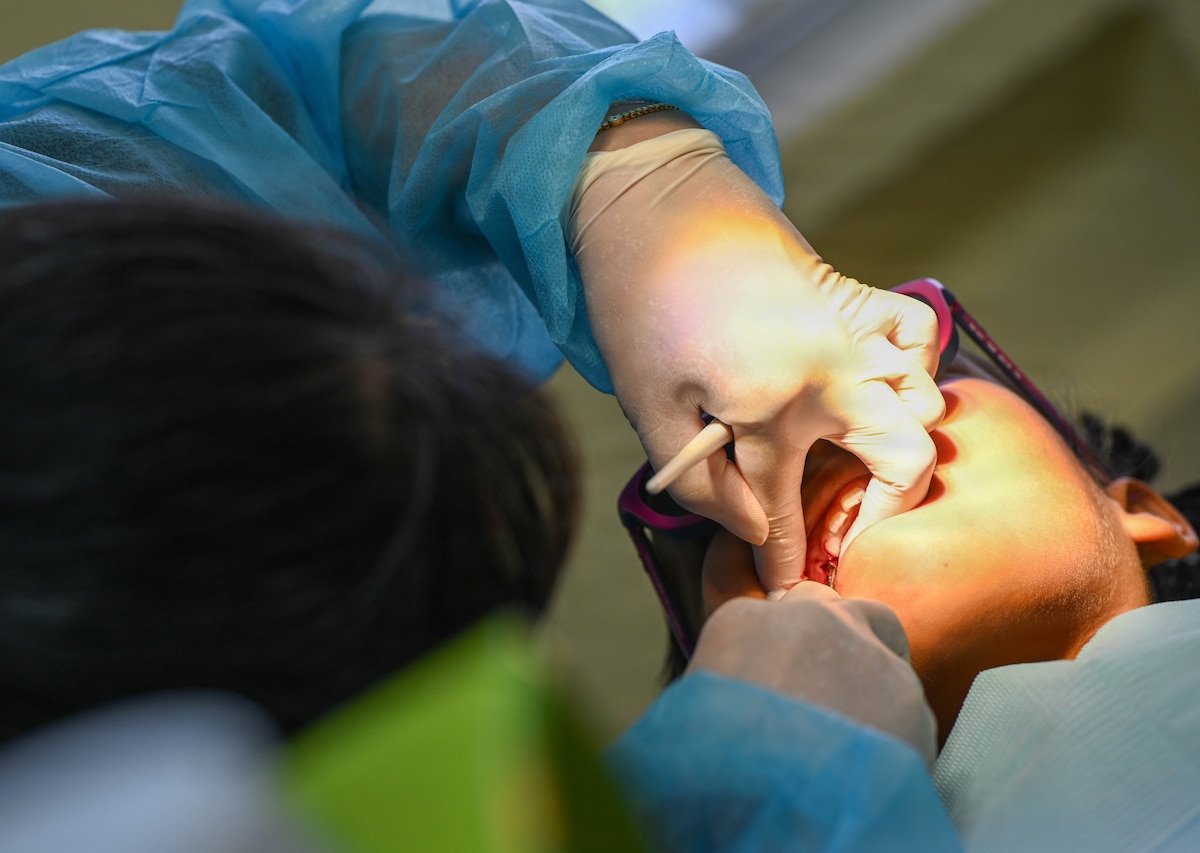 A U.S. Air Force Reserve dentist administers local anesthesia to a pediatric patient at Cheddi Jagan Dental School in Georgetown, Guyana, March 18, 2026.  During the Lesser Antilles Medical Assistance Team (LAMAT) 2026 mission, Air Force dental teams focused on preventive care and early intervention to address issues before they progress. (U.S. Air Force photo by Staff Sgt. Dakota Carter)