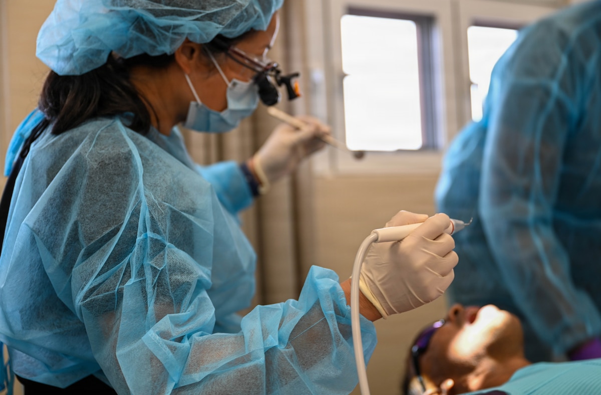 U.S. Air Force Lt. Col. Eirleen Hyun, 349th Medical Squadron dentist, performs a dental procedure at De Kinderen Regional Hospital in West Coast Demerara, Guyana, March 17, 2026.  During the Lesser Antilles Medical Assistance Team (LAMAT) 2026 mission, early intervention and routine care helped reduce the need for more complex dental treatments while improving overall patient outcomes. (U.S. Air Force photo by Staff Sgt. Dakota Carter)