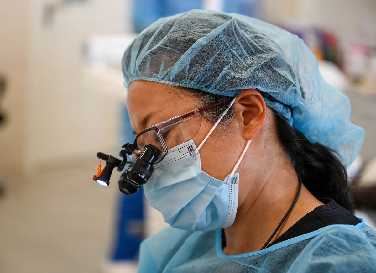 U.S. Air Force Lt. Col. Eirleen Hyun, 349th Medical Squadron dentist, performs a dental procedure at De Kinderen Regional Hospital in West Coast Demerara, Guyana, March 17, 2026. The Lesser Antilles Medical Assistance Team (LAMAT) 2026 mission focused on building medical readiness and strengthening professional bonds through hands-on clinical engagement with host nation counterparts. (U.S. Air Force photo by Staff Sgt. Dakota Carter)