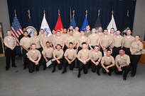 DAHLGREN, Va. (March 27, 2026) Fire Controlman (Aegis) “A” School pilot graduates pose for a group photo after a graduation ceremony at Surface Combat Systems Training Command AEGIS Training and Readiness Center onboard Naval Support Facility Dahlgren, Virginia, Mar. 27.  (U.S. Navy photo by Michael Bova)