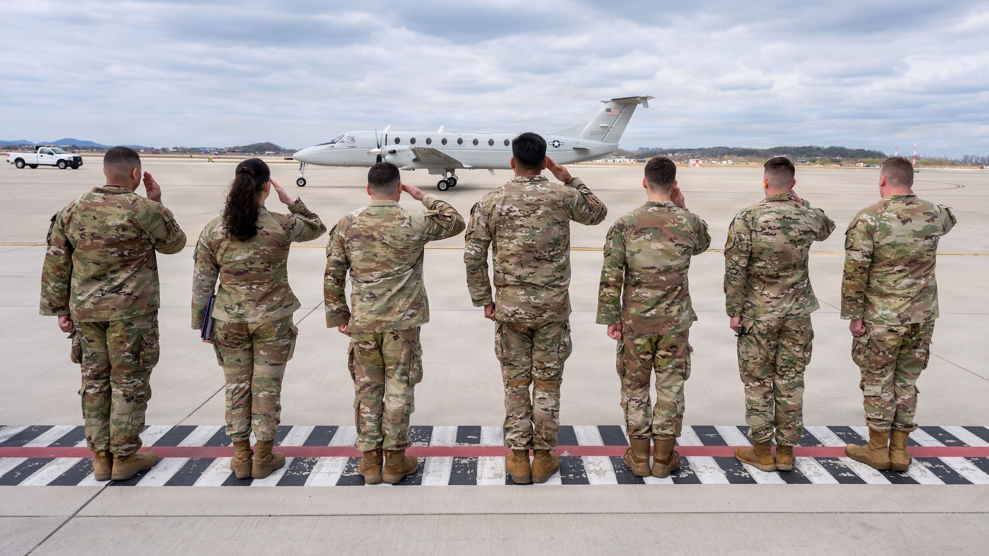 U.S. Air Force Airmen assigned to the 731st Air Mobility Squadron render a salute for the arrival of Eighteenth Air Force Leadership at Osan Air Base, Republic of Korea, March 31, 2026. The visit reinforced the importance of leadership presence in understanding and supporting Airmen at the tactical level. (U.S. Air Force photo by Senior Airman Rome Bowermaster)