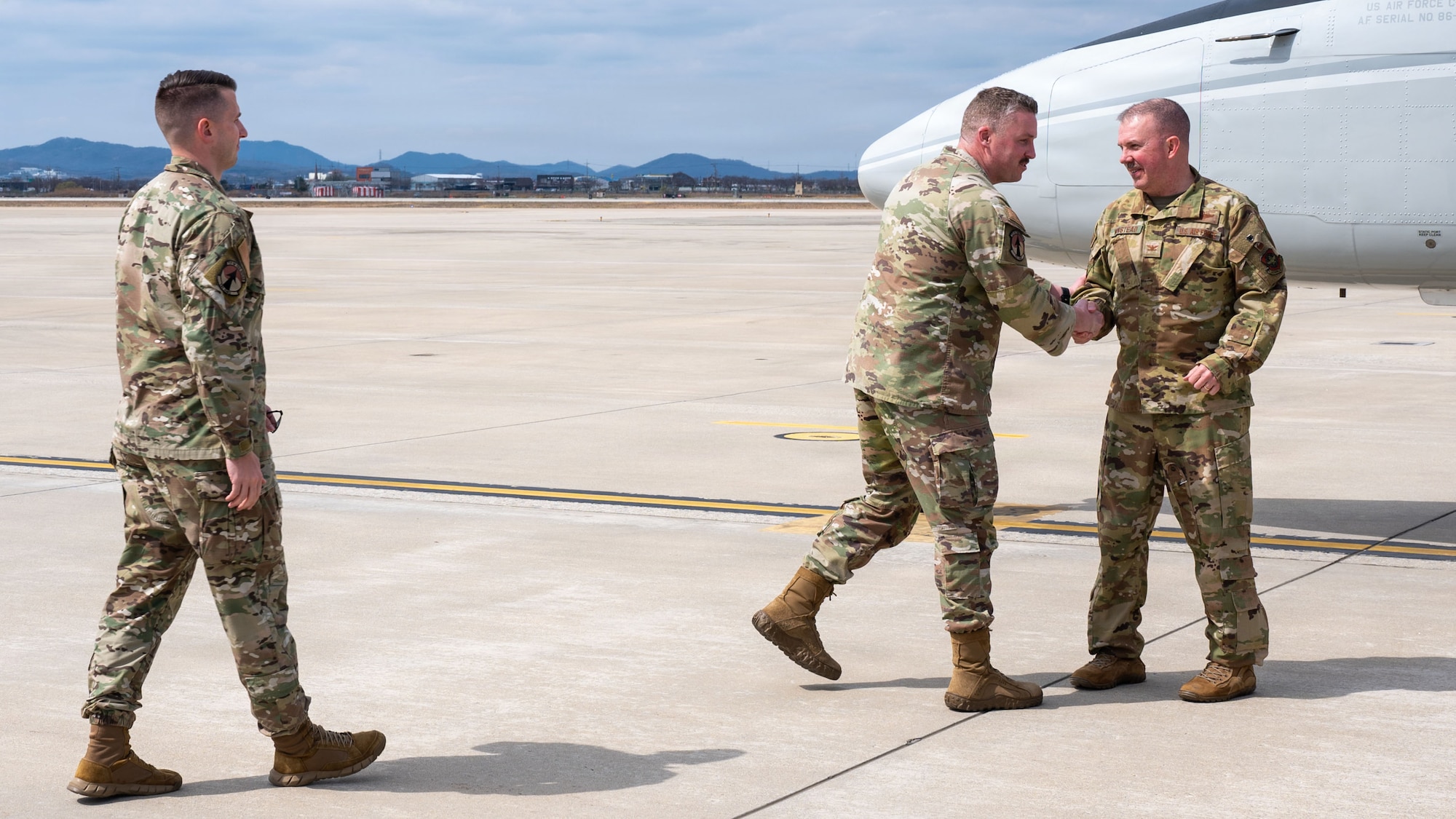 U.S. Air Force Col. Patrick Winstead, right, Eighteenth Air Force deputy commander, greets Lt. Col. Matthew Tegeler, 731st Air Mobility Squadron director of operations, at Osan Air Base, Republic of Korea, March 31, 2026. The visit provided an opportunity for senior leadership to engage with Airmen and gain insight into daily operations supporting the mission at Osan Air Base. (U.S. Air Force photo by Senior Airman Rome Bowermaster)