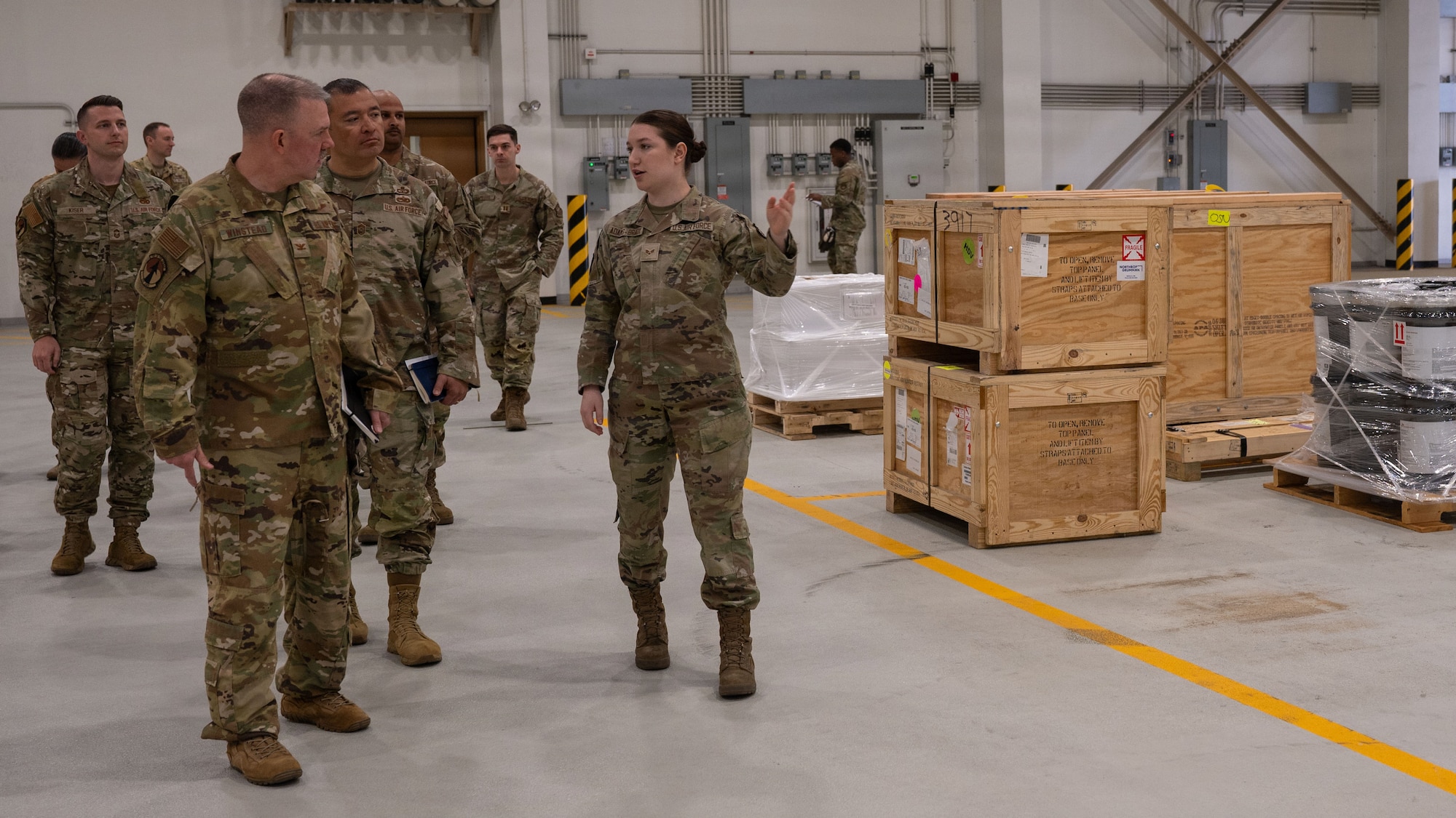 U.S. Air Force Col. Patrick Winstead, left, Eighteenth Air Force deputy commander, and Chief Master Sgt. Joseph Arce, center, 18th AF command chief, receives a brief from Senior Airman Linzi Adams-Brady, 731st Air Mobility Squadron special handling supervisor, at Osan Air Base, Republic of Korea, April 1, 2026. Col. Winstead engaged with Airmen to discuss mission priorities, challenges and opportunities to enhance readiness. (U.S. Air Force photo by Senior Airman Rome Bowermaster)