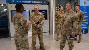 U.S. Air Force Col. Patrick Winstead, center, Eighteenth Air Force deputy commander, and Chief Master Sgt. Joseph Arce, right, 18th AF command chief, receives a brief from Staff Sgt. Rasheed Singleton, 731st Air Mobility Squadron passenger service supervisor, at Osan Air Base, Republic of Korea, April 1, 2026. Leadership engagements like this strengthen communication and ensure alignment across units supporting the mission at Osan. (U.S. Air Force photo by Senior Airman Rome Bowermaster)