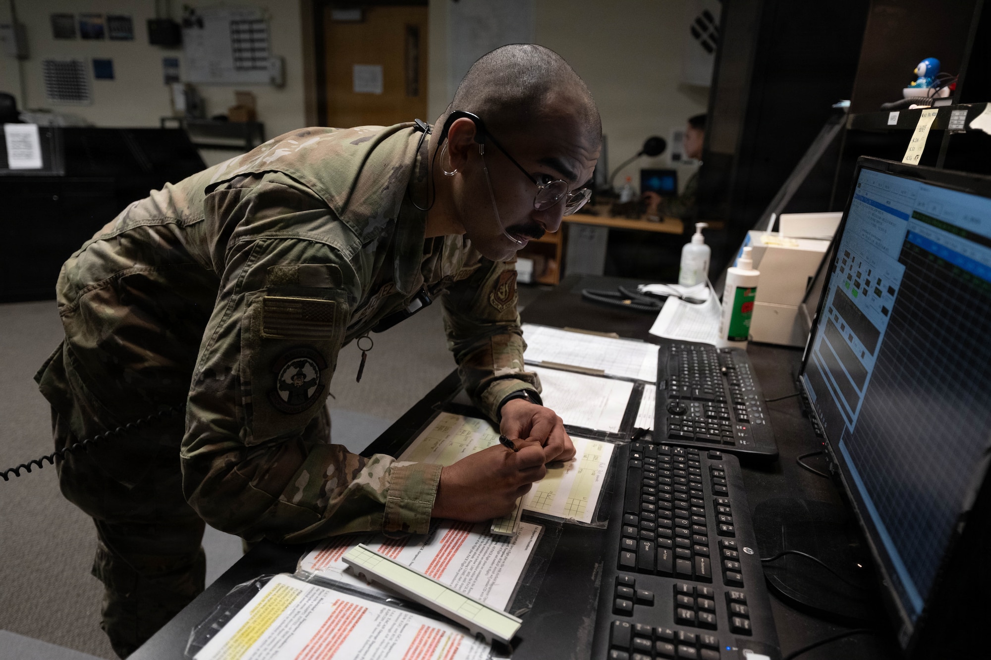 Airman conducts air traffic control operations.