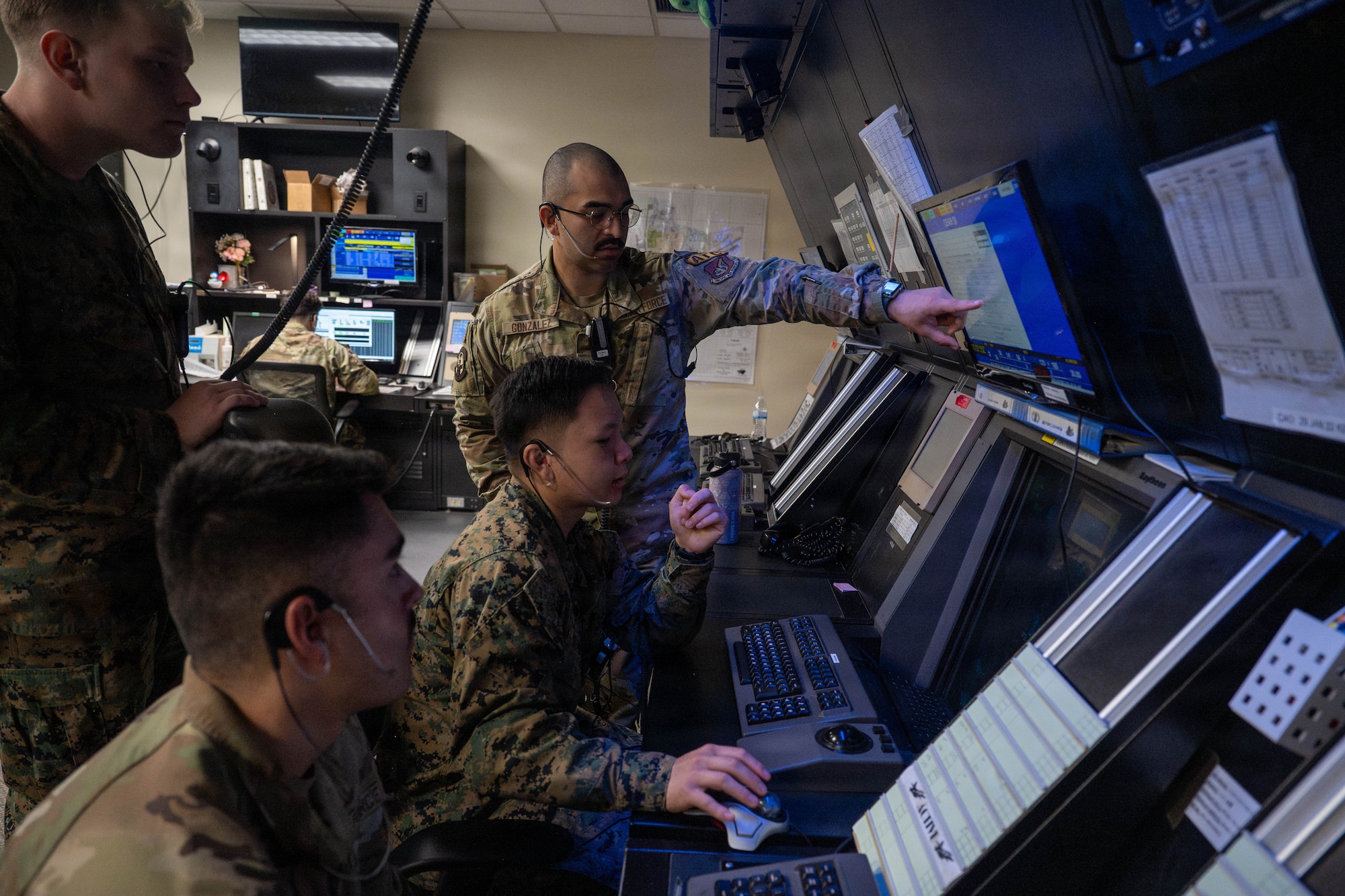 Service members work together during an air traffic controller exchange program training.