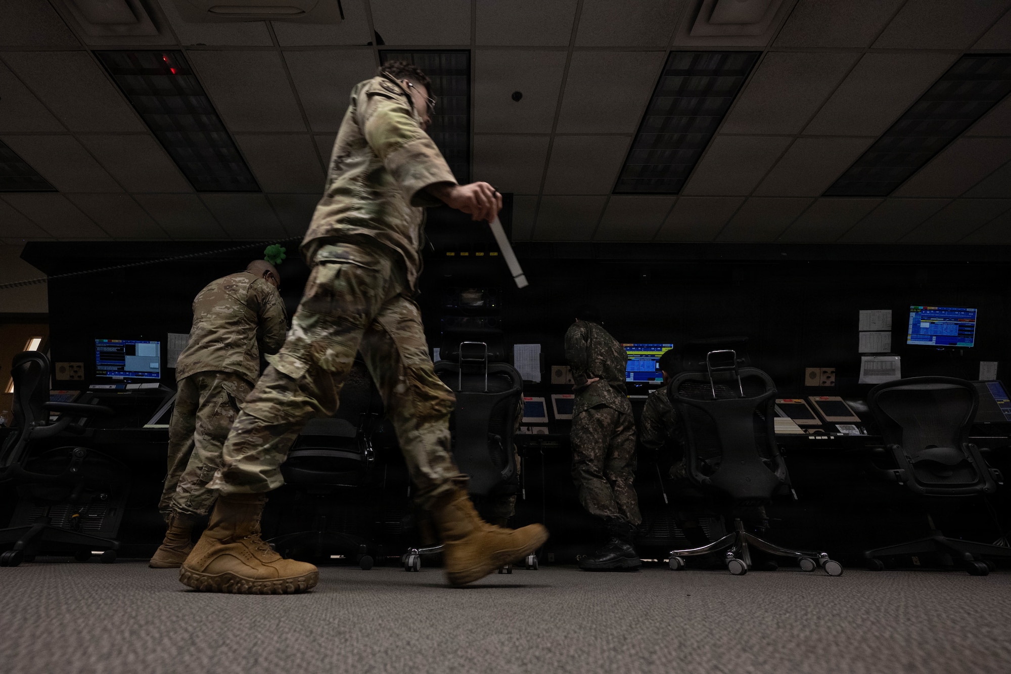 Service members work together at an air traffic control center.