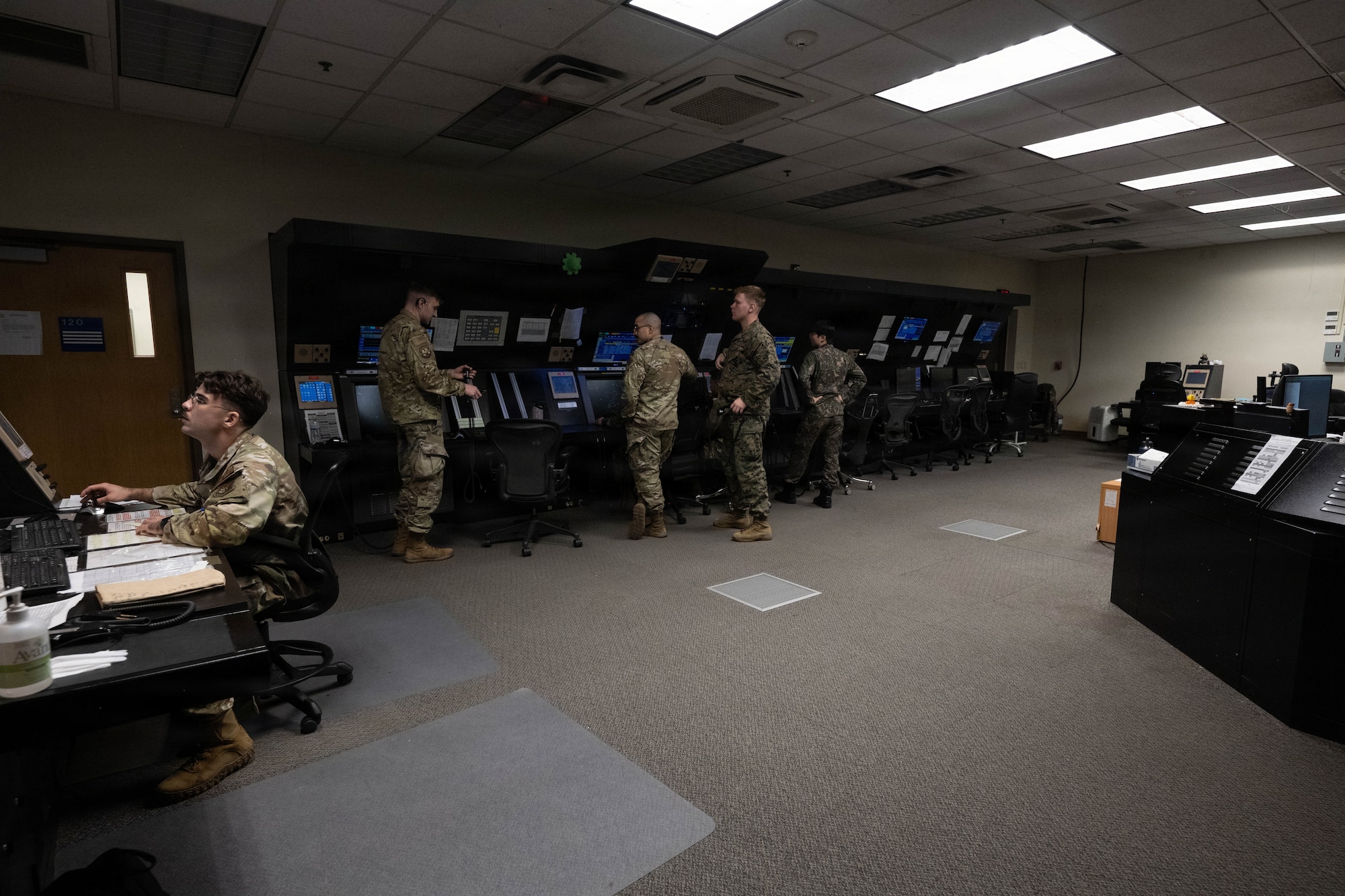 Joint forces work together in air traffic control center.