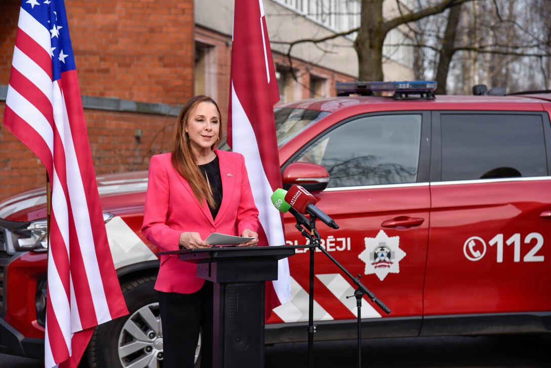 woman speaking while standing behind podium