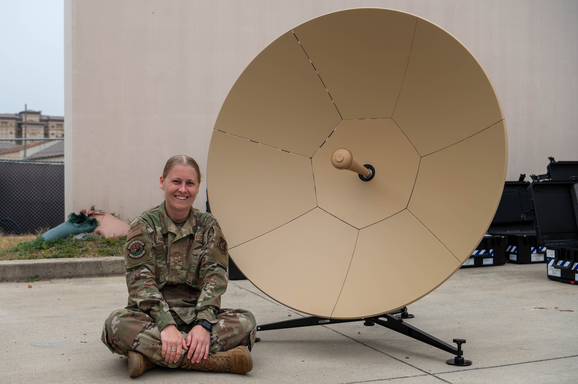 U.S. Air Force Airman 1st Class Allison Hinkle, 8th Communications Squadron radio technician, poses next to a flyaway satellite communication terminal at Kunsan Air Base, Republic of Korea, April 1, 2026. Hinkle was selected as the Wolf Pack’s Pride of the Pack for the week of March 30-April 3 due to her achievements within her career field and her impact on the readiness and well-being of the Wolf Pack. (U.S. Air Force photo by Staff Sgt. Cedrique Oldaker)