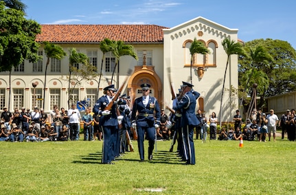 U.S. Air Force Capt. Andrew Paquin, center, officer in charge of operations with the U.S. Air Force Honor Guard, marches through spinning weapons during a drill team performance in Honolulu, March 28, 2026. The drill team performed at a Junior ROTC drill competition at President William McKinley High School as the headline event prior to the JROTC awards ceremony. (U.S. Air Force photo by Staff Sgt. Jordan Powell)