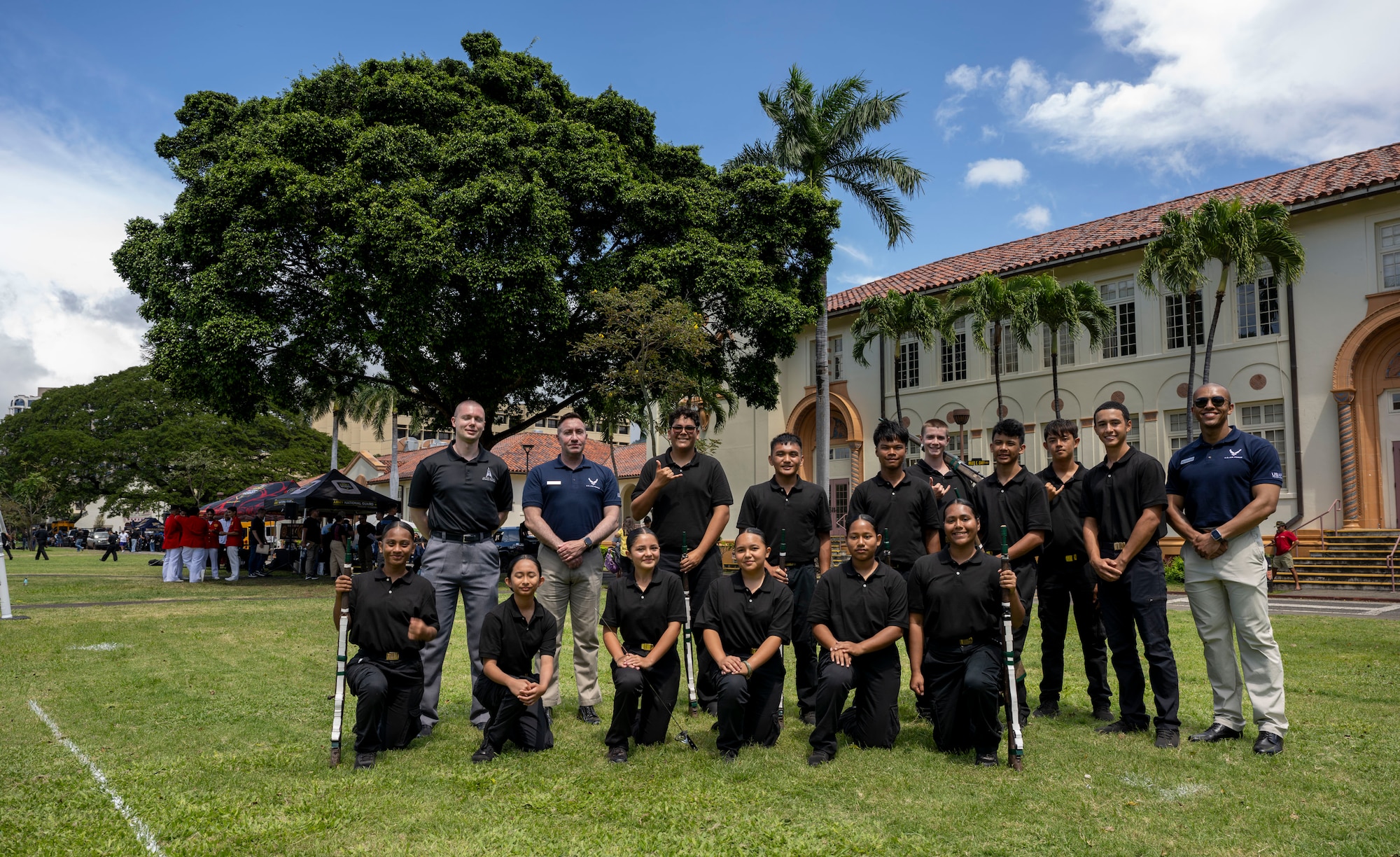U.S. Air Force Honor Guard members and Konawaena High School Junior ROTC cadets gather for a photo in Honolulu, March 28, 2026. The Air Force ceremonial guardsmen served as judges during the Pacific Regional Drill Meet at President William McKinley High School, providing scores and feedback to participating high school JROTC cadets from across Hawaii. (U.S. Air Force photo by Staff Sgt. Jordan Powell)