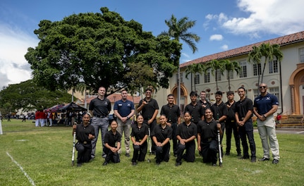 U.S. Air Force Honor Guard members and Konawaena High School Junior ROTC cadets gather for a photo in Honolulu, March 28, 2026. The Air Force ceremonial guardsmen served as judges during the Pacific Regional Drill Meet at President William McKinley High School, providing scores and feedback to participating high school JROTC cadets from across Hawaii. (U.S. Air Force photo by Staff Sgt. Jordan Powell)