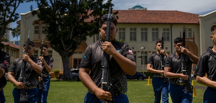 U.S. Marine Corps Junior ROTC cadets from Kapolei High School perform their armed team exhibition drill routine during the Pacific Regional Drill Meet in Honolulu, March 28, 2026. The team was evaluated and scored by members of the U.S. Air Force Honor Guard, who provided feedback following the performance. (U.S. Air Force photo by Staff Sgt. Jordan Powell)