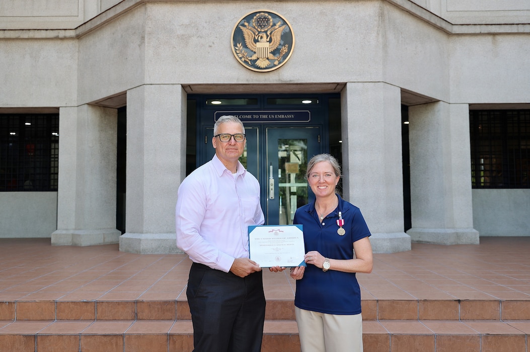 SINGAPORE (March 18, 2026) Lt. Cmdr. Dawn Weir, a microbiologist with Naval Medical Research Unit (NAMRU) INDO PACIFIC, receives the Meritorious Service Medal from Capt. Nicholas Martin, commanding officer of NAMRU INDO PACIFIC. NAMRU INDO PACIFIC, part of Navy Medicine Research & Development, conducts research, surveillance and studies of vaccines, therapeutic agents, diagnostic assays and vector control measures in the INDOPACOM Area of Responsibility to better prevent and treat infectious diseases in support of Navy, Marine Corps and joint U.S. warfighter health, readiness and lethality. (U.S. Embassy photo by Abdullah Safuan/released)
