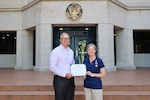 SINGAPORE (March 18, 2026) Lt. Cmdr. Dawn Weir, a microbiologist with Naval Medical Research Unit (NAMRU) INDO PACIFIC, receives the Meritorious Service Medal from Capt. Nicholas Martin, commanding officer of NAMRU INDO PACIFIC. NAMRU INDO PACIFIC, part of Navy Medicine Research & Development, conducts research, surveillance and studies of vaccines, therapeutic agents, diagnostic assays and vector control measures in the INDOPACOM Area of Responsibility to better prevent and treat infectious diseases in support of Navy, Marine Corps and joint U.S. warfighter health, readiness and lethality. (U.S. Embassy photo by Abdullah Safuan/released)