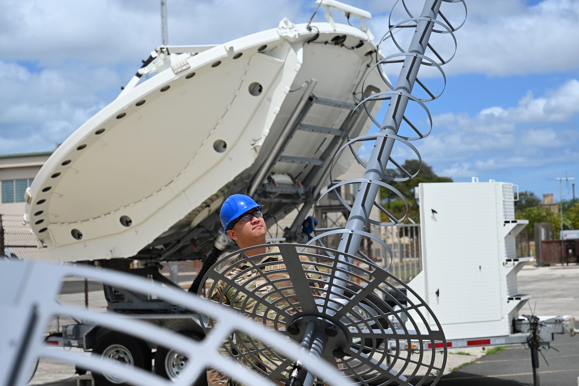 Air Force Senior Airman Mike Herreros, 109th Electromagnetic Warfare Squadron, Hawaii Air National Guard, inspects antenna equipment at Joint Base Pearl Harbor-Hickam, Hawaii, at the start of Resolute Space, July 8, 2025. Nested under the 2025 Department of the Air Force exercise series, Resolute Space 2025 demonstrates the Space Force’s preparedness for complex, large-scale military operations by exercising its ability to operate in a contested, dynamic environment against high-end threats on short notice across the service and with joint and international partners. (U.S. Space Force photo by Lt. Col. Victoria Hight)