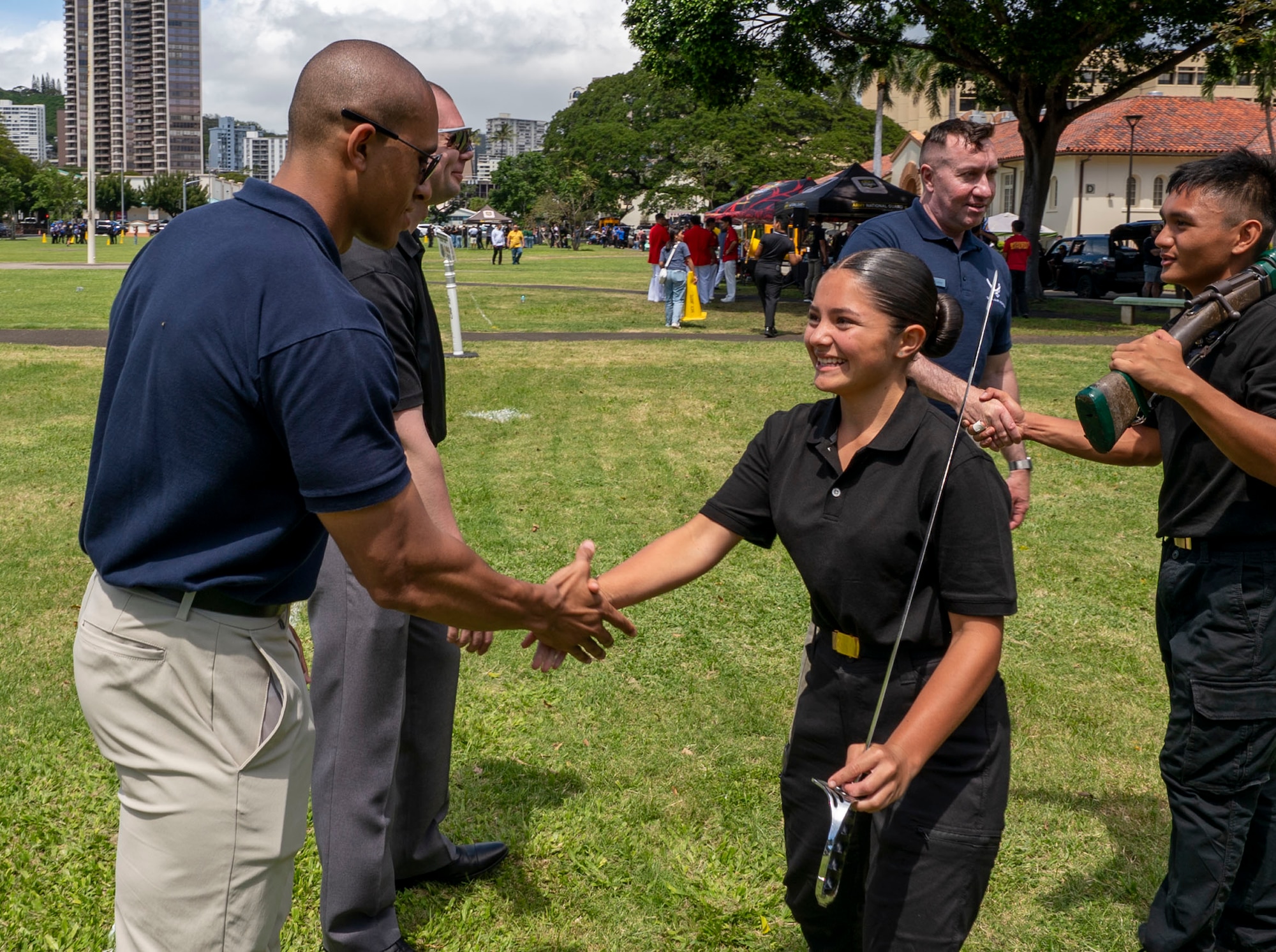 U.S. Air Force Staff Sgt. Joshua Alvord, left, training flight instructor with the U.S. Air Force Honor Guard, greets cadet Country Denis, Junior ROTC drill commander at Konawaena High School, during the Pacific Regional Drill Meet in Honolulu, March 28, 2026. The competition took place at President William McKinley High School with more than 15 school teams participating from other Hawaiian Islands and Guam. (U.S. Air Force photo by Staff Sgt. Jordan Powell)