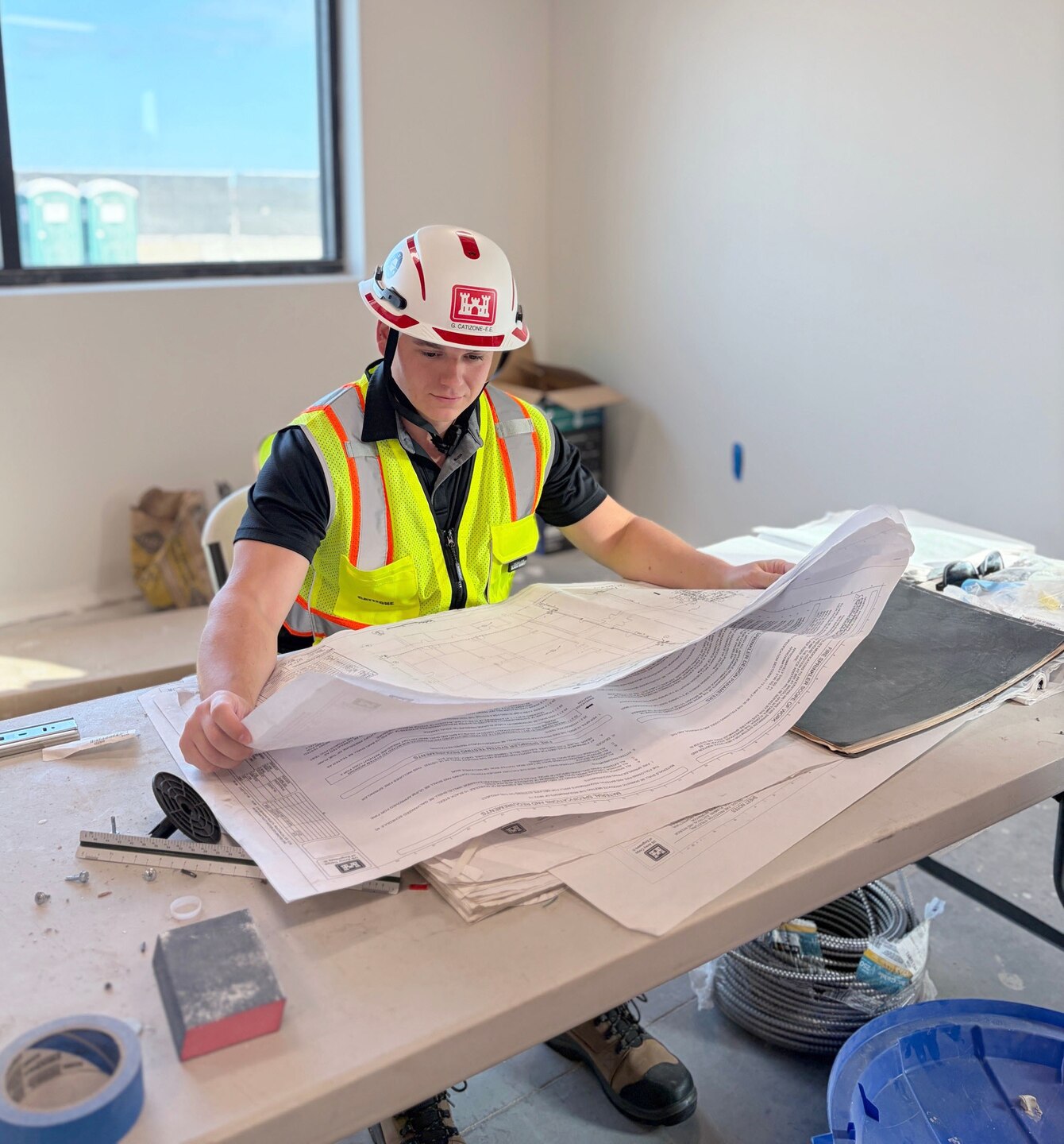 Picture of a person reading blueprints