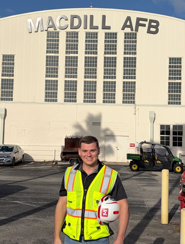 Picture of a man standing in front of a building/