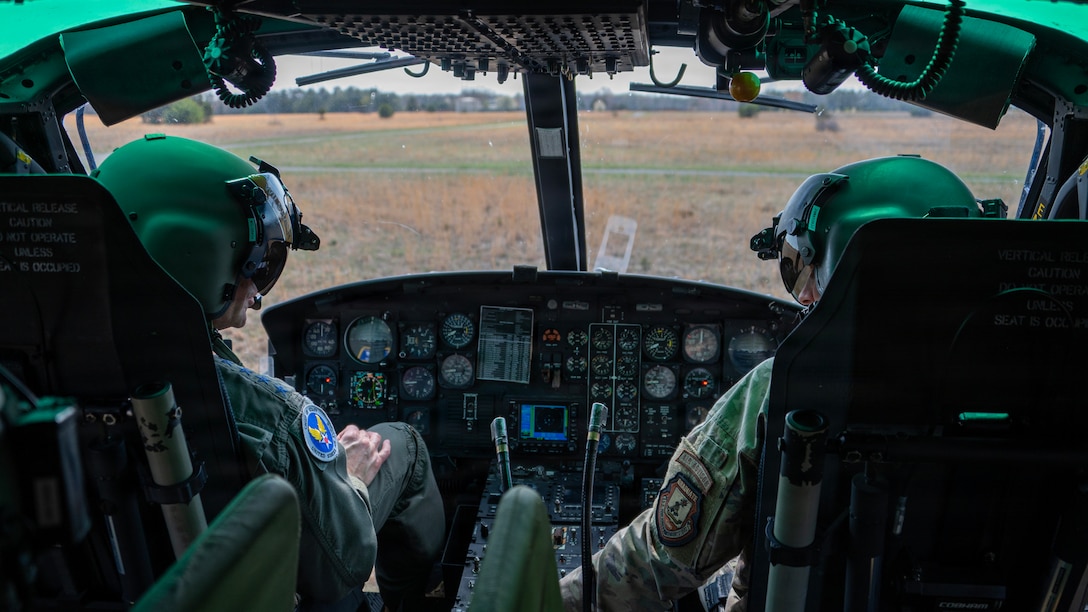 Air Force Chief of Staff Gen. Ken Wilsbach, left, and Lt. Col. Zach Minner, 1st Helicopter Squadron commander and instructor pilot, pilot a UH-1N Huey.