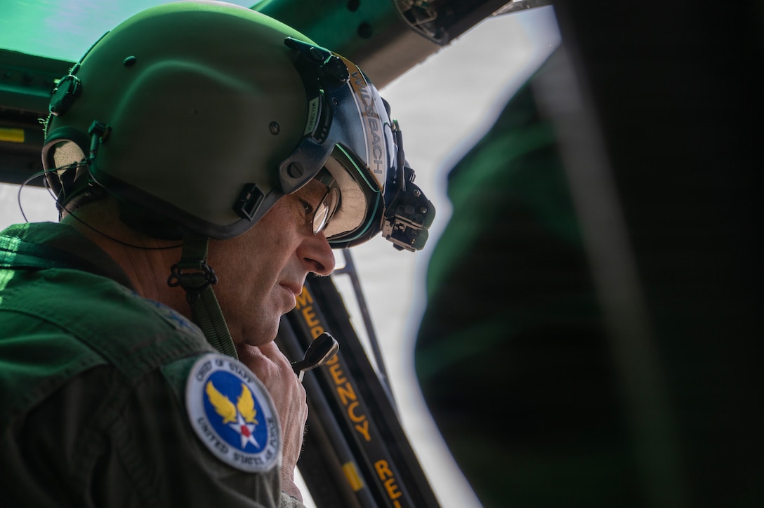 Air Force Chief of Staff Gen. Ken Wilsbach adjusts his helmet before co-piloting a UH-1N Huey.