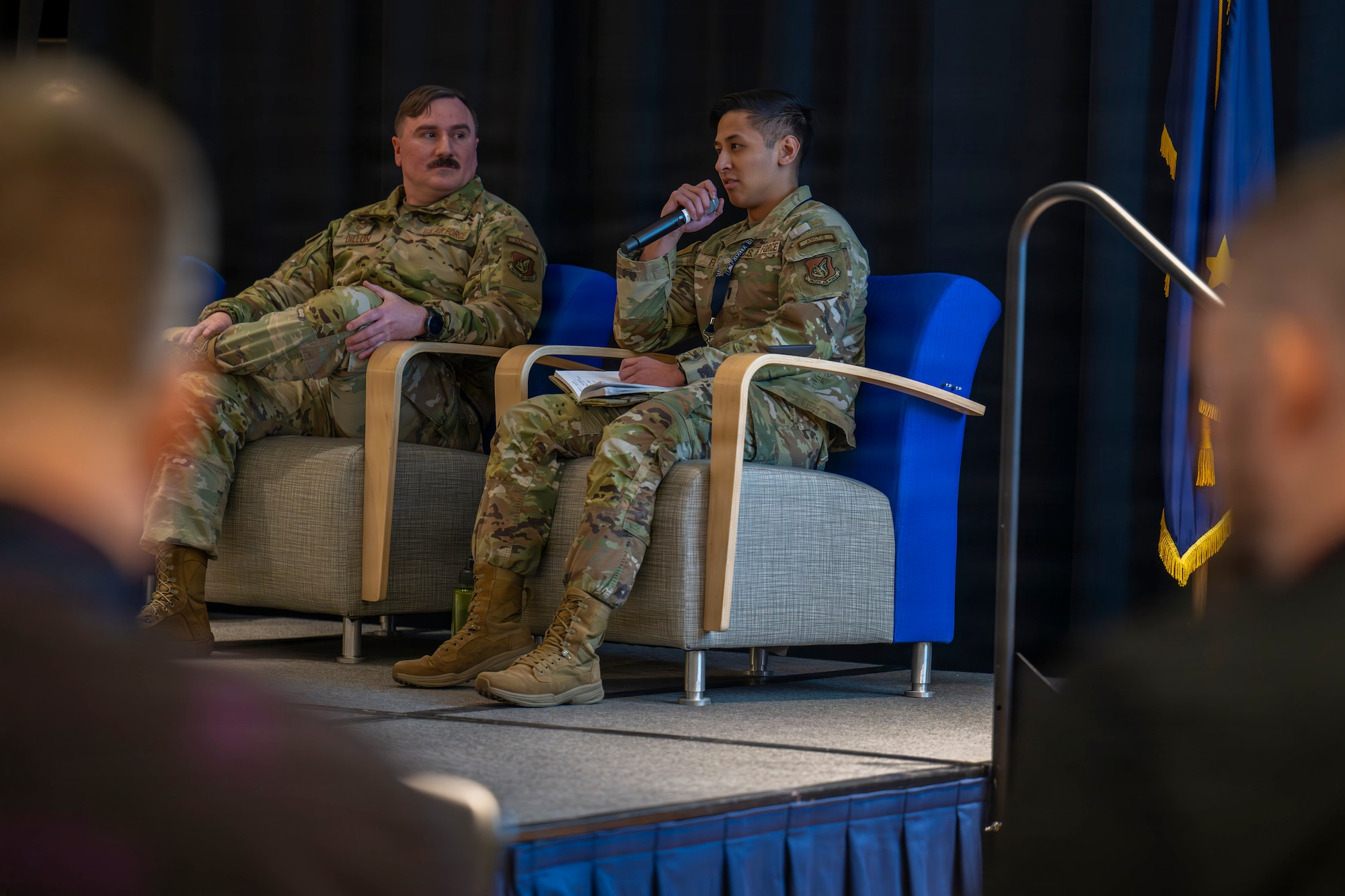 U.S. Air Force Tech. Sgt. Joseph Dillon, 1st Combat Weather Squadron Detachment 3 aviation operations NCOIC, left, and 1st Lt. Brandon Flores, 1st CWS DET 3 aviation weather operations officer in charge, right, speaks during a panel at the Arctic Meteorological and Oceanographic (METOC) Partnership Summit at Fairbanks, Alaska, March 27, 2026.