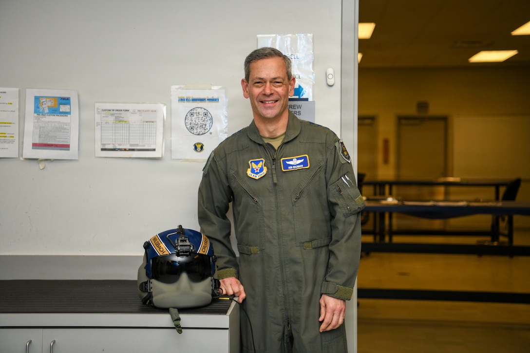 Air Force Chief of Staff Gen. Ken Wilsbach stands with a custom helmet from the 1st Helicopter Squadron.