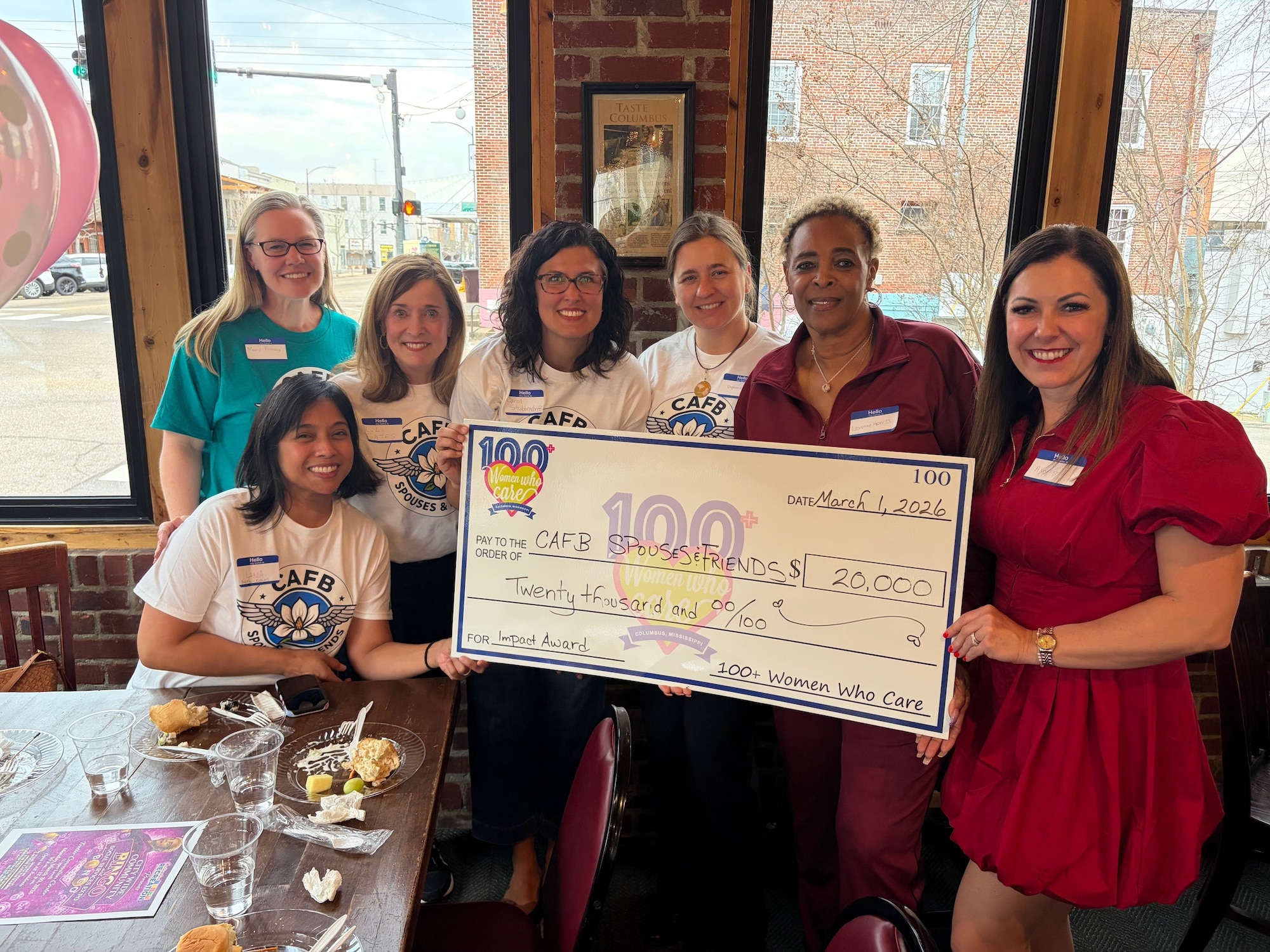 Members of the Columbus Air Force Base Spouses & Friends Club holding a check in Columbus, Ms., March 1, 2026.
